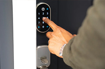 Photo of someone using a Yale smart lock
