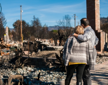 Couple looking at a home after a wildfire