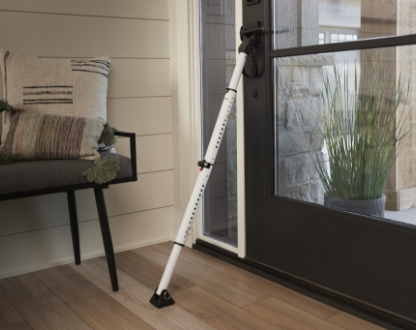 master lock door bar leaning against a entry door