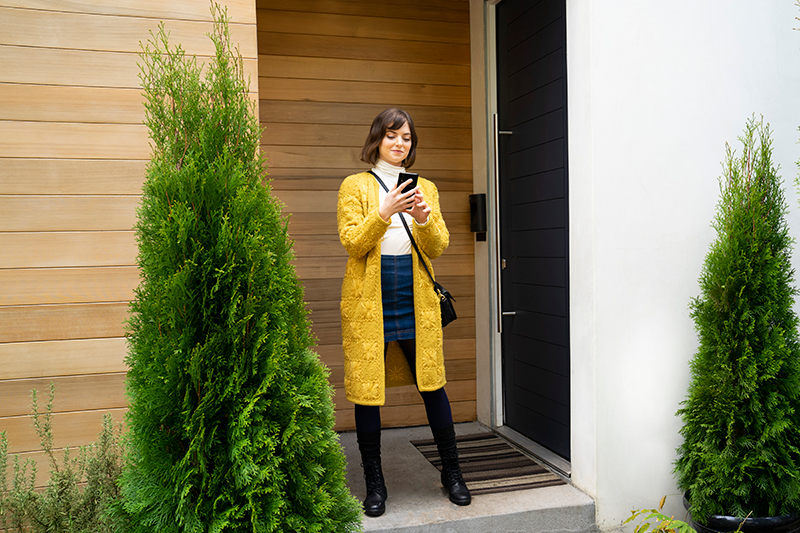 Woman checking phone outside