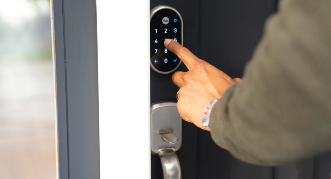 Photo of someone using a Yale smart lock